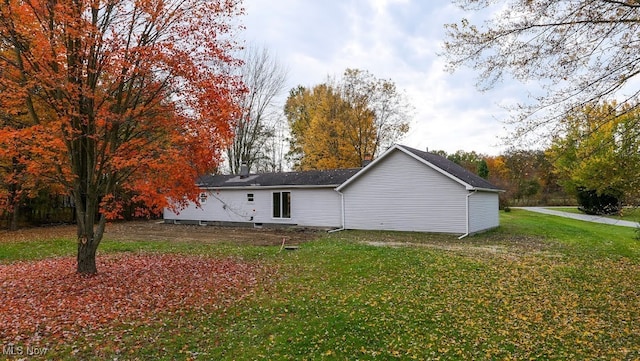 rear view of property with a yard