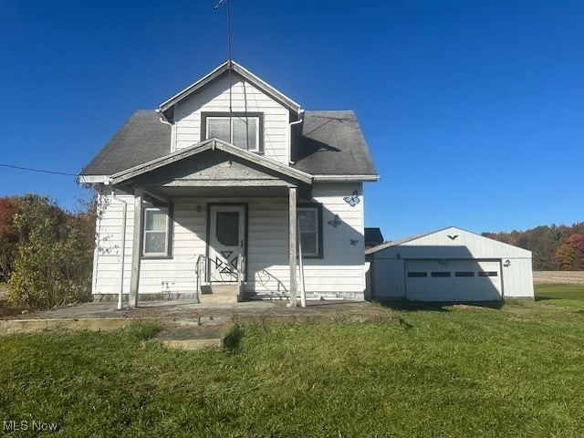 bungalow featuring a porch, a front lawn, and a garage