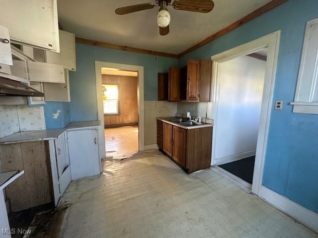 7433 State Route 7, Andover, OH 44003 - kitchen with a ceiling fan, light countertops, brown cabinets, crown molding, and light flooring