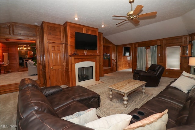 living room featuring vaulted ceiling, light carpet, a textured ceiling, and wood walls