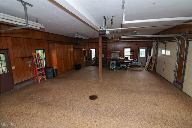 garage with wooden walls and a garage door opener