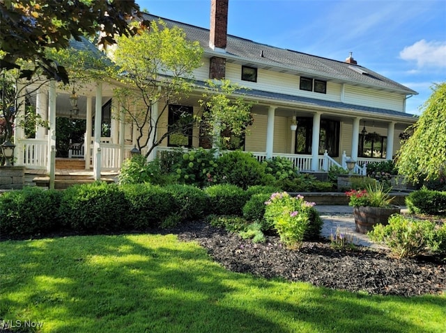 view of front of house with covered porch and a front yard