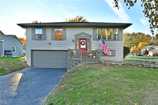 bi-level home with a front yard and a garage