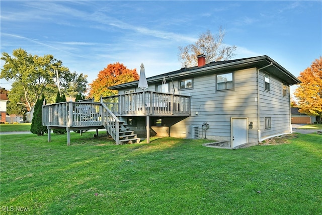 back of property with a deck, a yard, and central air condition unit