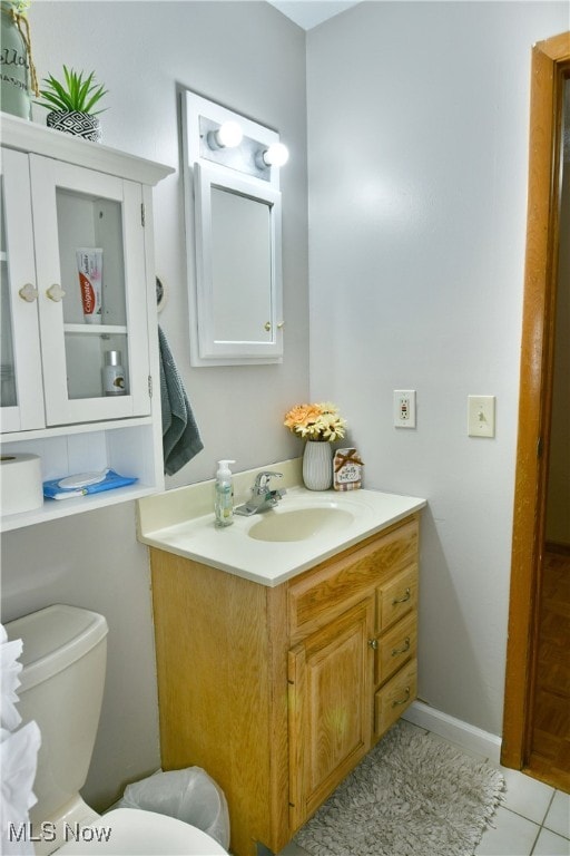 bathroom featuring tile patterned floors, vanity, and toilet