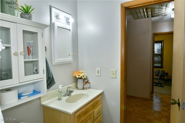 bathroom with vanity and parquet floors