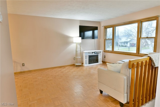 living room with a textured ceiling and parquet floors