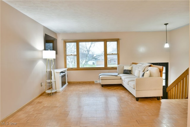 unfurnished living room featuring light parquet floors