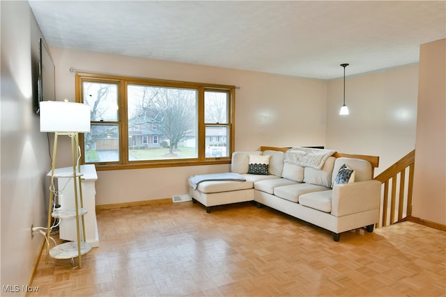 living room featuring plenty of natural light and light parquet flooring