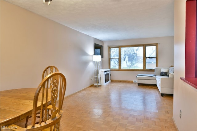 interior space featuring a textured ceiling and light parquet floors