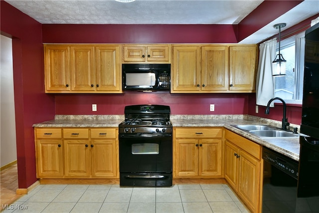 kitchen with sink, pendant lighting, a textured ceiling, light tile patterned floors, and black appliances