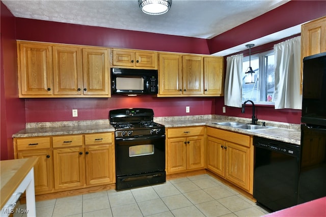 kitchen with black appliances, sink, light tile patterned floors, a textured ceiling, and decorative light fixtures