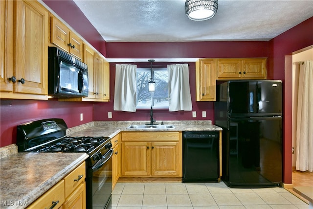 kitchen featuring light tile patterned flooring, a textured ceiling, sink, and black appliances