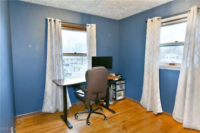 office featuring a textured ceiling and hardwood / wood-style flooring