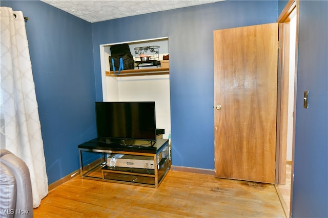 interior space featuring light hardwood / wood-style floors and a textured ceiling