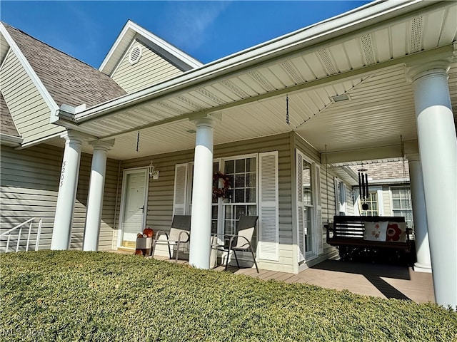 view of exterior entry with covered porch