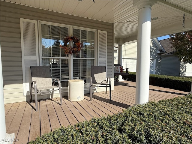 wooden terrace with a porch