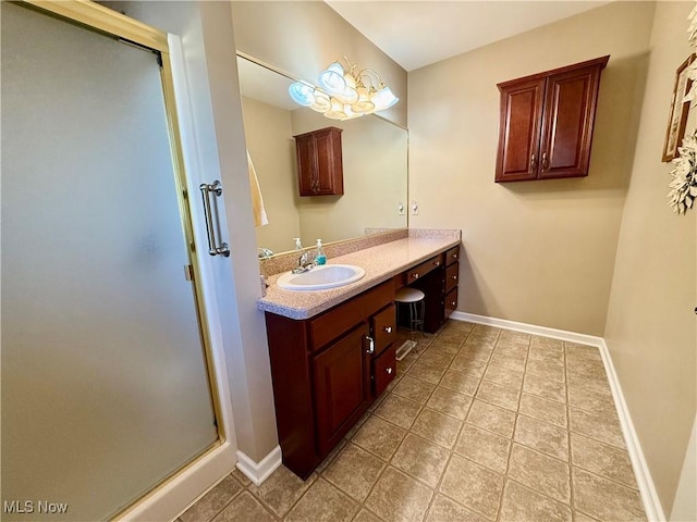 bathroom featuring tile patterned floors, an inviting chandelier, vanity, and walk in shower