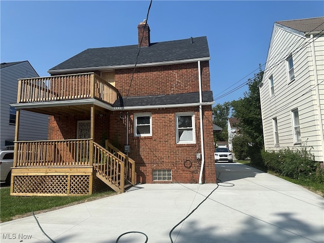 rear view of house featuring a balcony