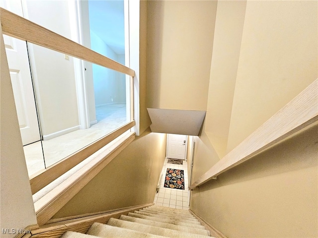 stairs featuring tile patterned floors