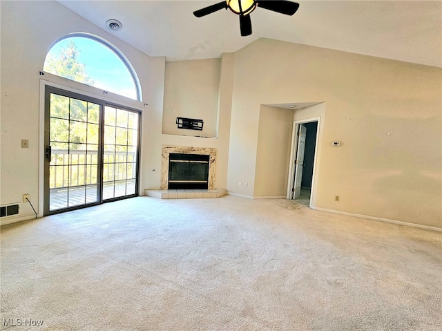 unfurnished living room with a tile fireplace, light colored carpet, high vaulted ceiling, and ceiling fan