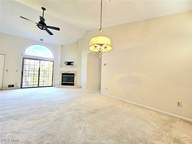 unfurnished living room with high vaulted ceiling, a fireplace, light colored carpet, and ceiling fan