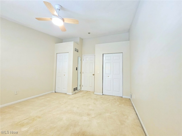 unfurnished bedroom with light carpet and ceiling fan