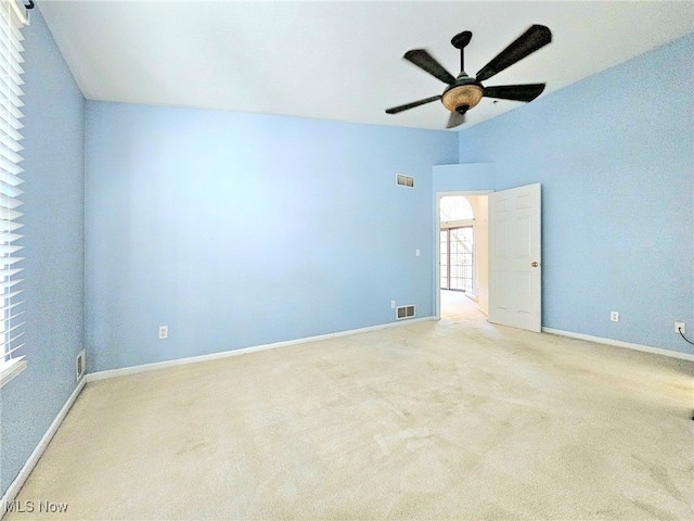 carpeted spare room featuring ceiling fan