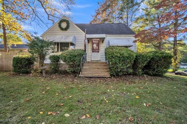 bungalow-style home with a front yard