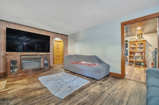 living room featuring a textured ceiling and hardwood / wood-style floors