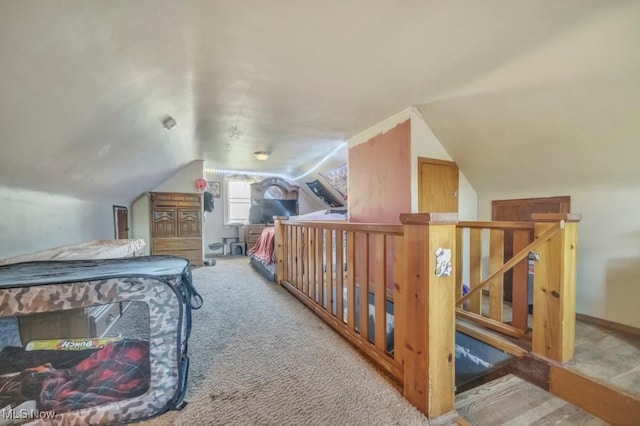 carpeted bedroom featuring lofted ceiling