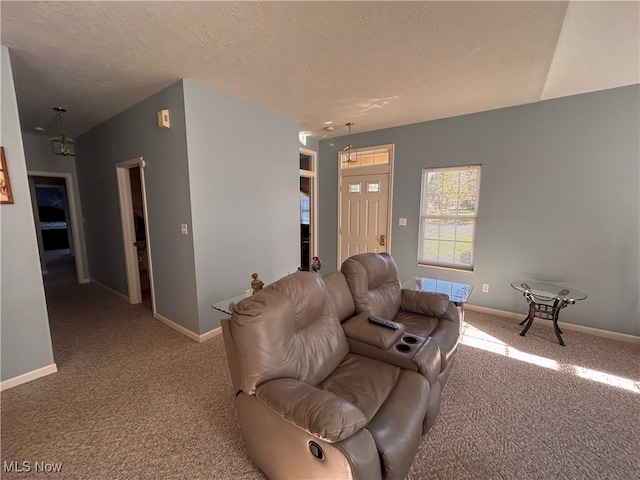 carpeted living room with a textured ceiling