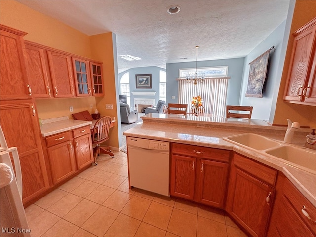 kitchen featuring an inviting chandelier, dishwasher, a textured ceiling, and pendant lighting