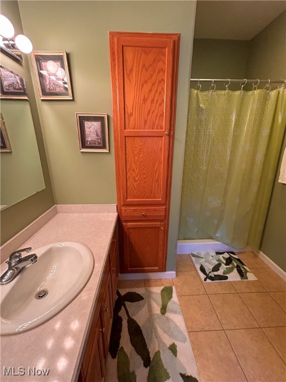 bathroom featuring vanity, a shower with curtain, and tile patterned flooring