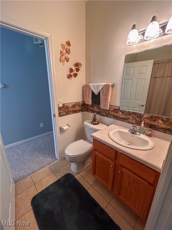 bathroom with vanity, toilet, and tile patterned floors