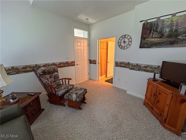 living area featuring light carpet