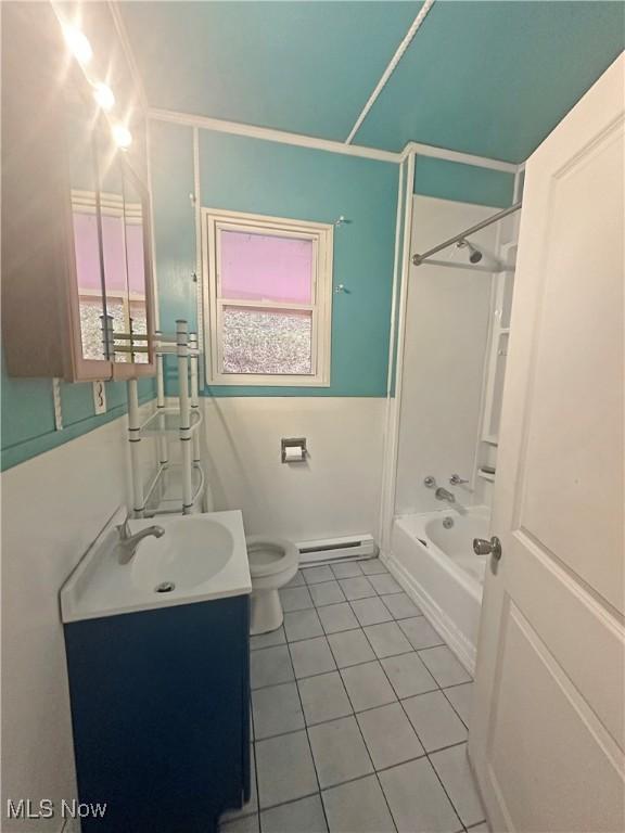 full bathroom featuring baseboard heating, tile patterned flooring, shower / bath combination, vanity, and toilet