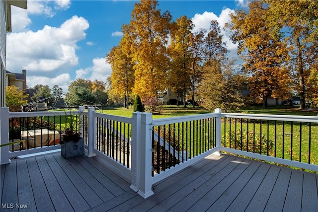 wooden terrace with a lawn