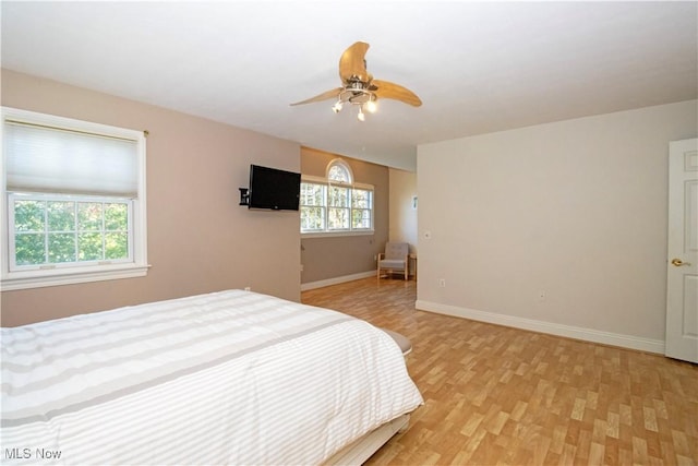 bedroom with ceiling fan and light hardwood / wood-style flooring