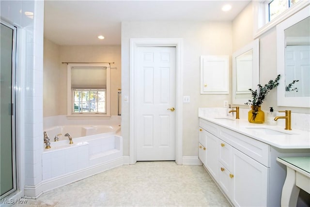 bathroom featuring vanity and independent shower and bath