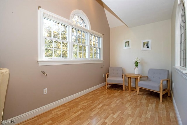 sitting room with lofted ceiling and light hardwood / wood-style floors