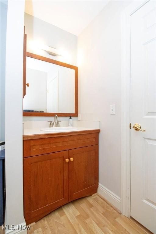 bathroom featuring wood-type flooring and vanity