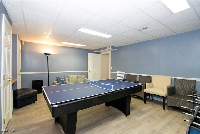 recreation room featuring a drop ceiling and light wood-type flooring