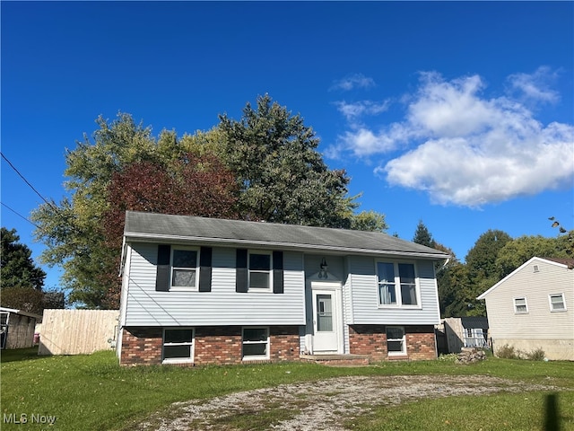 split foyer home with a front lawn