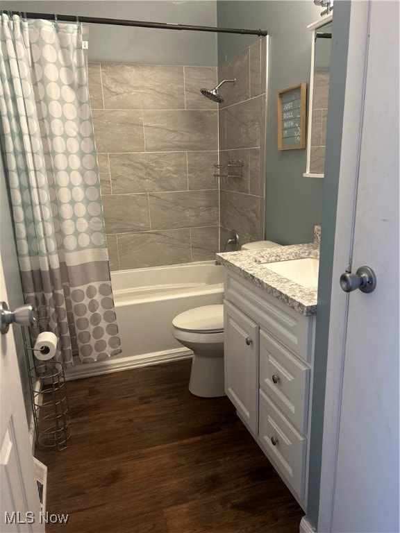 full bathroom with vanity, hardwood / wood-style flooring, toilet, and shower / bath combo with shower curtain