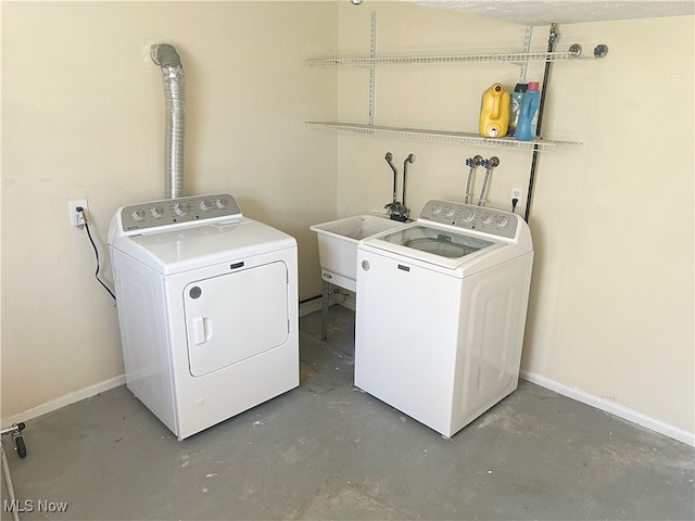 washroom featuring sink and washing machine and clothes dryer