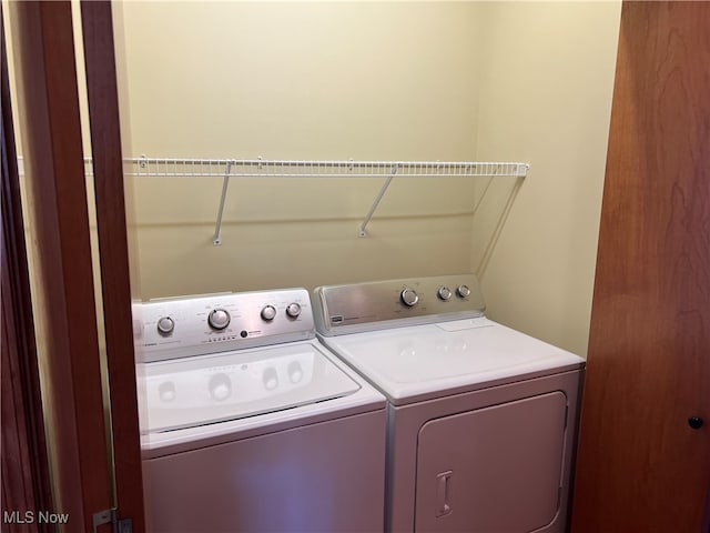 clothes washing area with independent washer and dryer