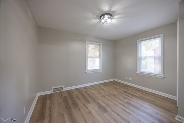 spare room with light hardwood / wood-style floors