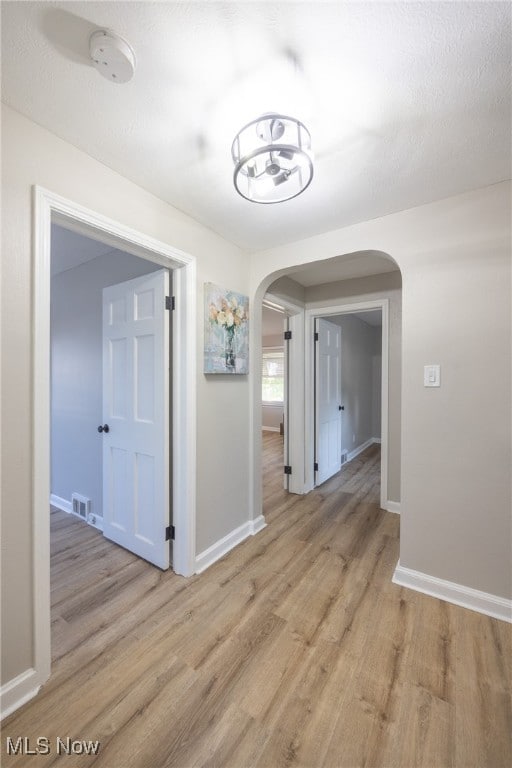 hall with light wood-type flooring