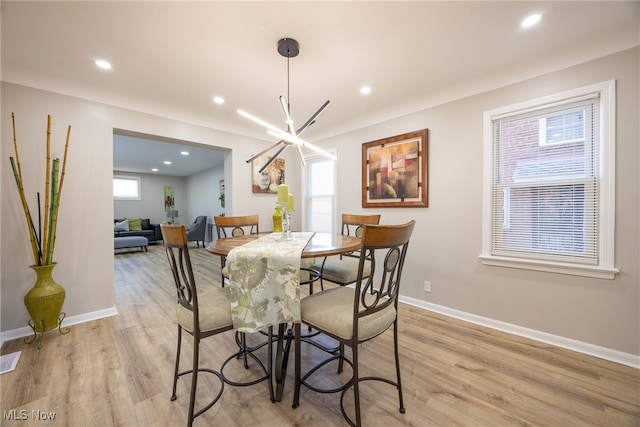 dining room featuring a chandelier and light wood-type flooring